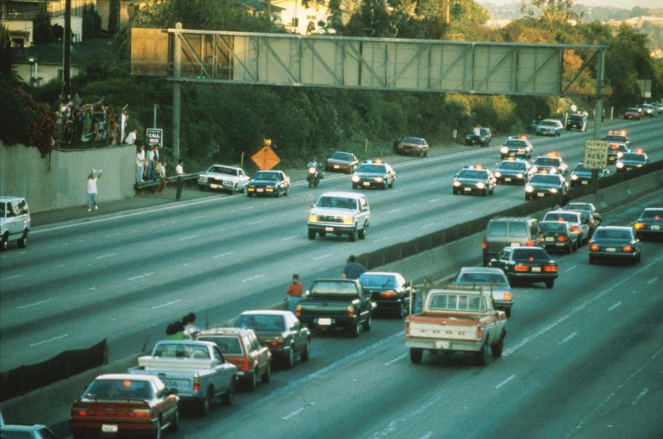 Drivers halted their vehicles to observe the pursuit of the white Ford Bronco, operated by Al Cowlings, with O.J. Simpson as a passenger, on the 405 freeway in Los Angeles on June 17, 1994.