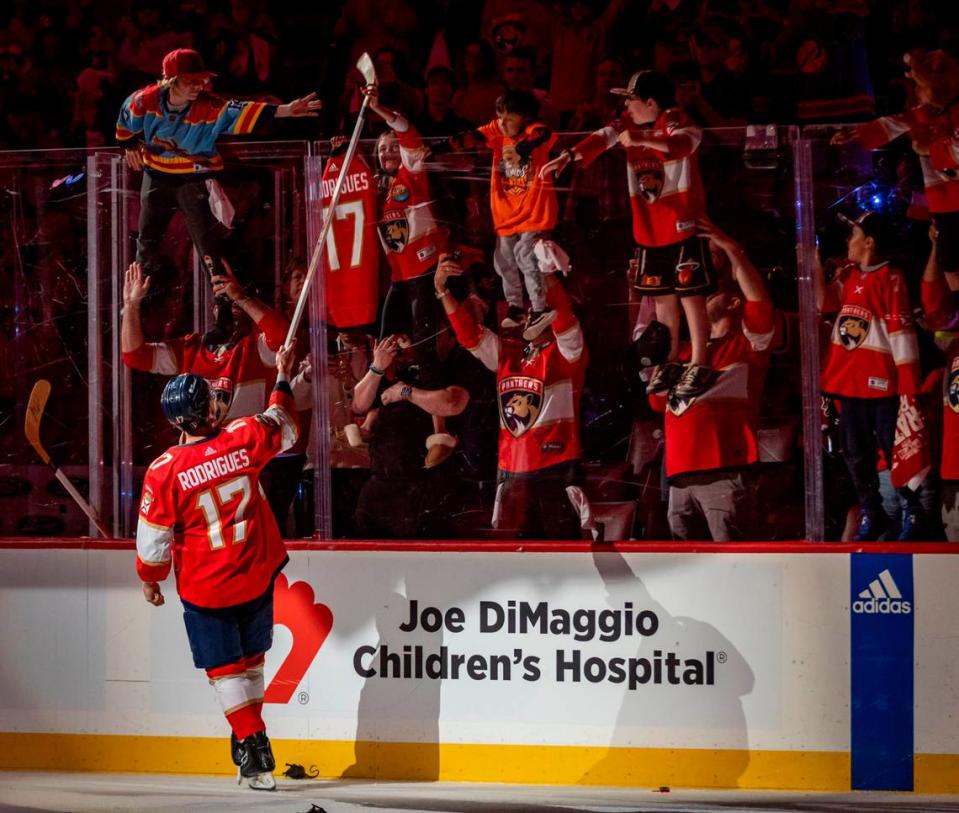 Sunrise, Florida, June 10, 2024 - Florida Panthers center Evan Rodrigues (17) who scored to goals in the game gives his stick to a fan after the game. The Florida Panthers defeated the Edmonton Oilers 4-1 in game 2 of the Stanley Cup Final to lead the series 2 -0. The series now moves to Edmonton .