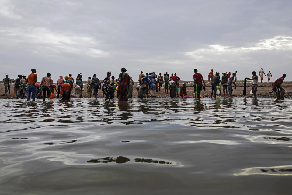 A July 2019 file photo shows Ethiopian migrants walking on the shores of Ras al-Ara, Lahj, Yemen, after disembarking from a boat. A boat carrying migrants sank off Yemen's coast on June 10, 2024, according to the U.N. immigration agency, killing at least 39 people and leaving dozens more missing. / Credit: Nariman El-Mofty/AP