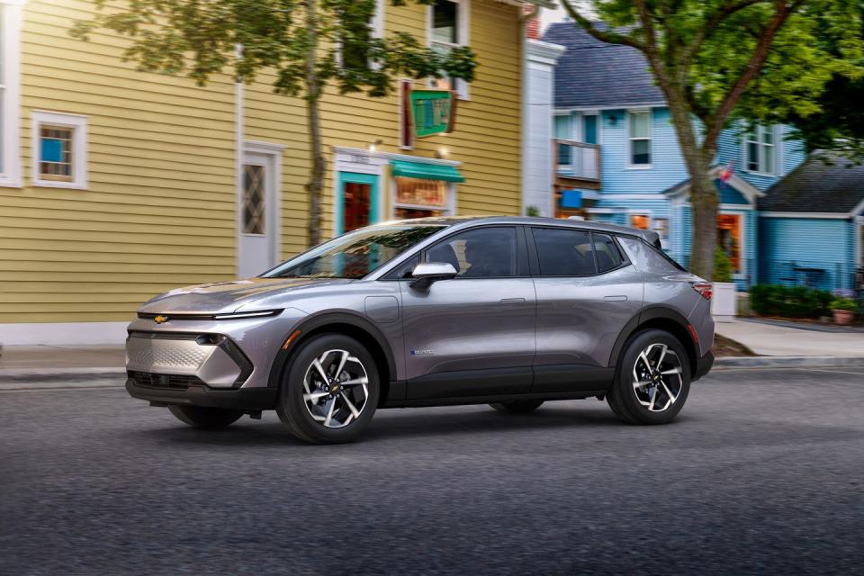 2024 chevrolet equinox ev driving down a small town street