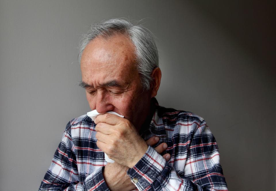 A man coughing