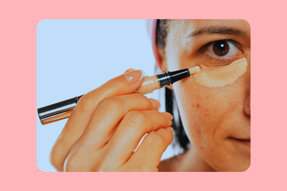 Woman applying concealer 