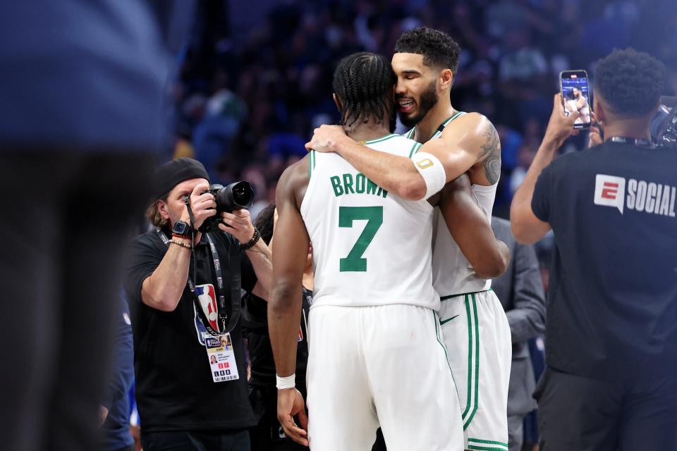 Jaylen Brown and Jayson Tatum embrace after the Celtics defeated the Mavericks in Game 3.