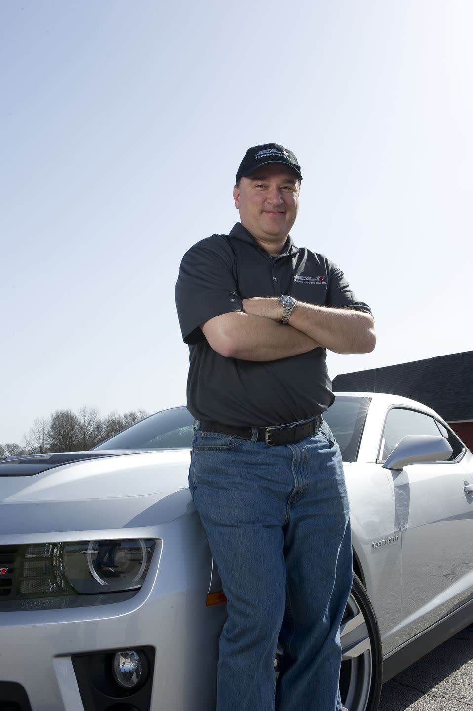 general motors chief engineer tony roma stands near camaro zl1 from 2013
