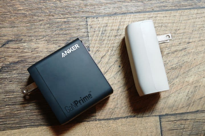 An Anker charger and a Belkin charger laying next to each other on a desk.