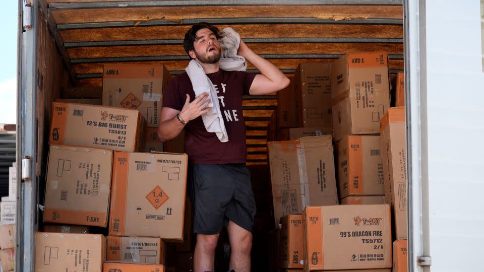 Ethan Hickman takes a break from unloading a trailer of fireworks in Weldon Spring, Missouri, on June 17, 2024. - Jeff Roberson/AP