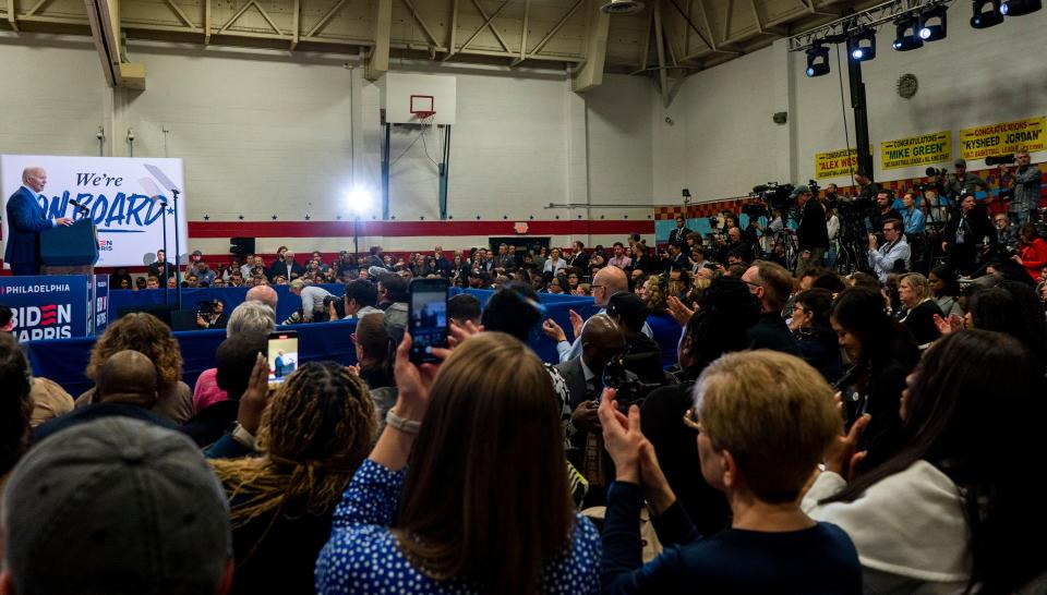 The crowd and members of the media listen as President Joe Biden, left, gives his speech during his re-election rally at the Martin Luther King Recreation Center in Philadelphia, Pennsylvania on April 18, 2024.