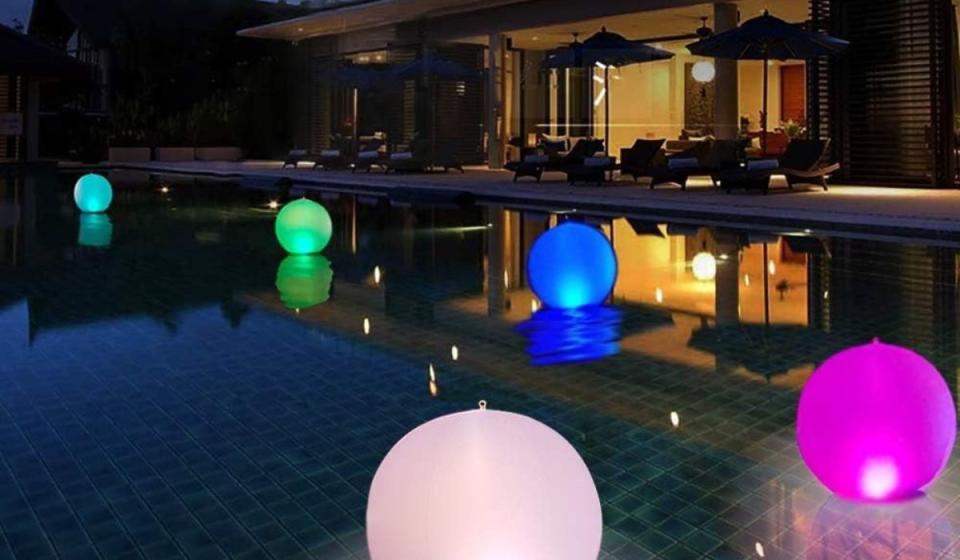 Nighttime at pool with glowing inflatable lights.