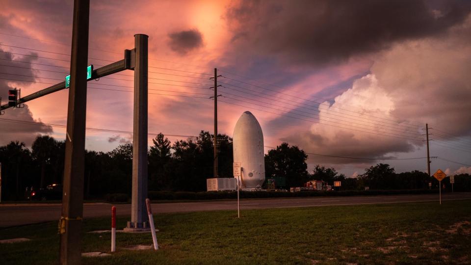 a large white cylinder with a nasa logo and an emblem reading 