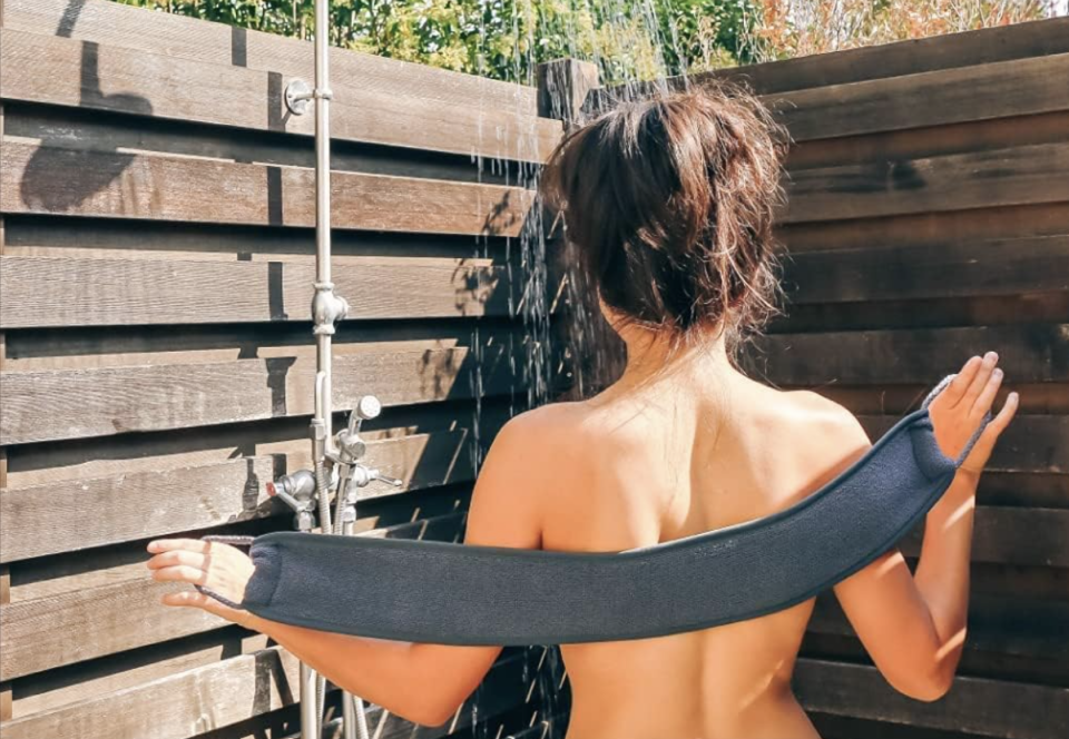 woman using Aquis Double-Sided Back Scrubber in the shower