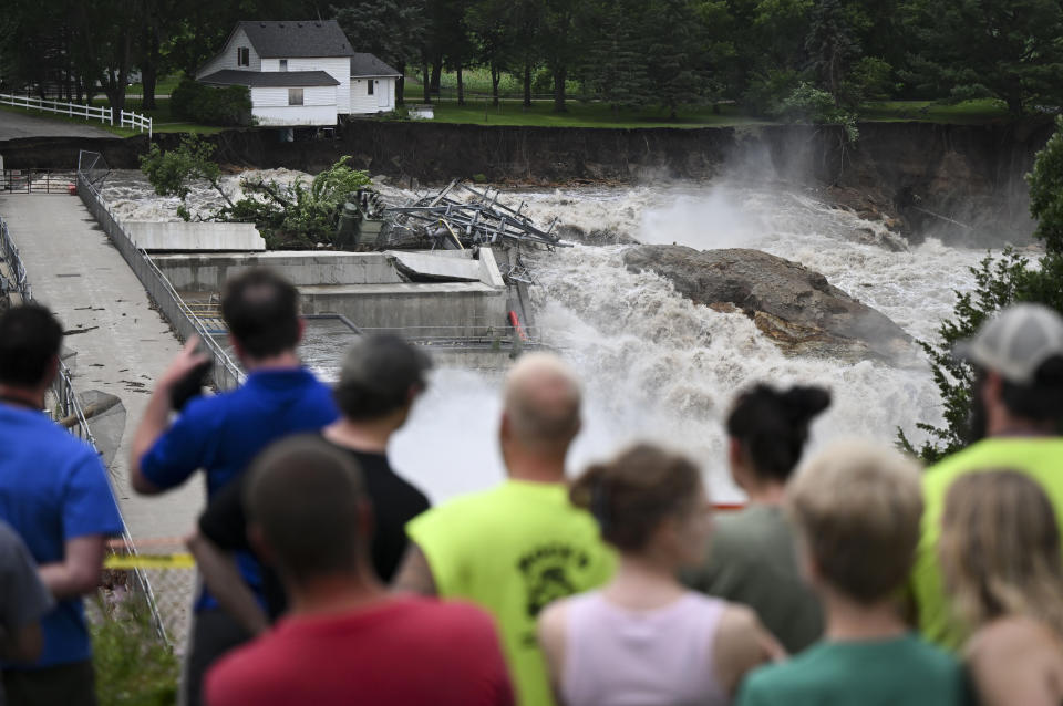 A home teeters on the brink of collapsing near the Rapidan Dam in Mankato, Minn., on Monday.