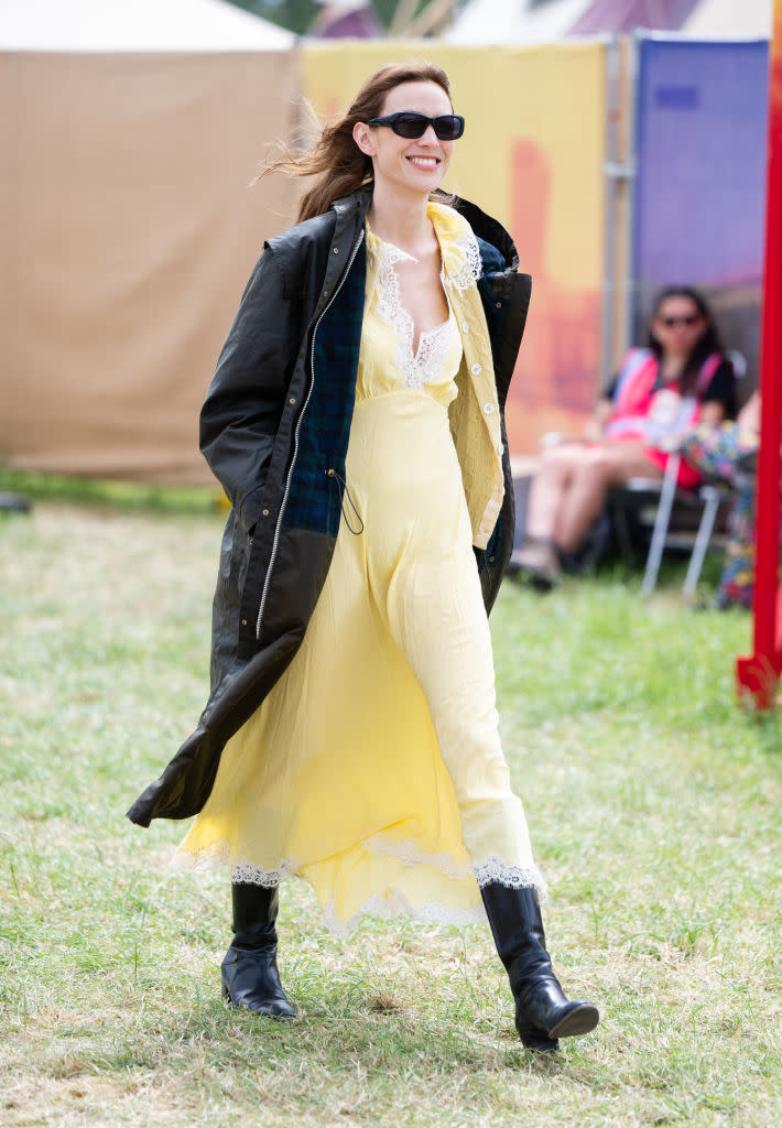 GLASTONBURY, ENGLAND - JUNE 28: Alexa Chung during day three of Glastonbury Festival 2024 in a yellow dress and boots at Worthy Farm, Pilton on June 28, 2024 in Glastonbury, England. Founded by Michael Eavis in 1970, Glastonbury Festival features around 3,000 performances across over 80 stages. Renowned for its vibrant atmosphere and iconic Pyramid Stage, the festival offers a diverse lineup of music and arts, embodying a spirit of community, creativity, and environmental consciousness. (Photo by Samir Hussein/WireImage)