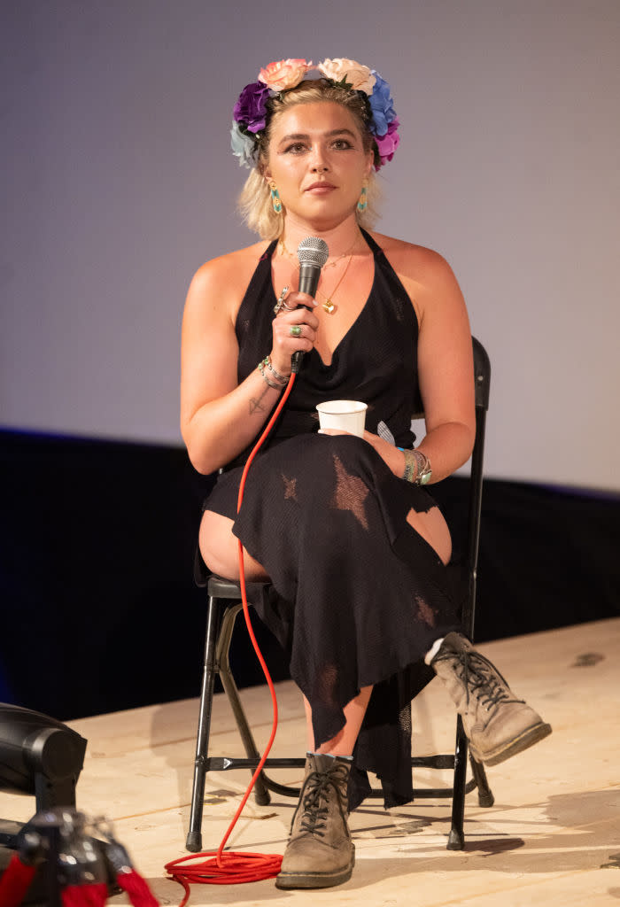 GLASTONBURY, ENGLAND - JUNE 28: Florence Pugh attends a Q&A session at the Pilton Palace in a dress and boots during day three of Glastonbury Festival 2024 at Worthy Farm, Pilton on June 28, 2024 in Glastonbury, England. Founded by Michael Eavis in 1970, Glastonbury Festival features around 3,000 performances across over 80 stages. Renowned for its vibrant atmosphere and iconic Pyramid Stage, the festival offers a diverse lineup of music and arts, embodying a spirit of community, creativity, and environmental consciousness. (Photo by Samir Hussein/WireImage)