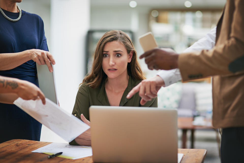 Shot of a young businesswoman looking anxious in a demanding office environment