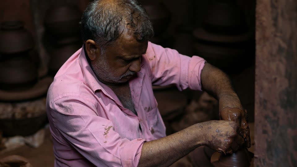 A potter works at his workshop in Dharavi on April 14. - Noemi Cassanelli/CNN