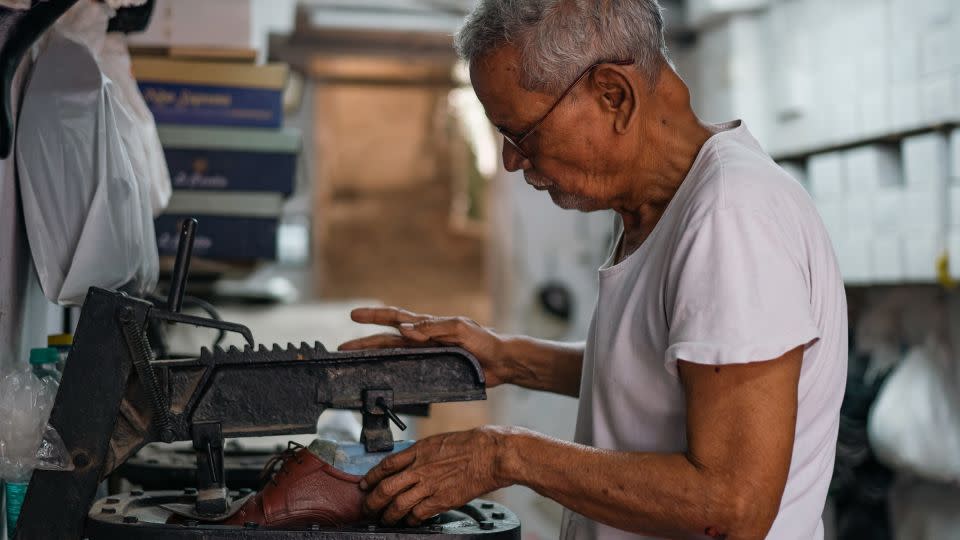 Masoom Ali Shaikh works at his workshop in Dharavi on April 14. - Noemi Cassanelli/CNN