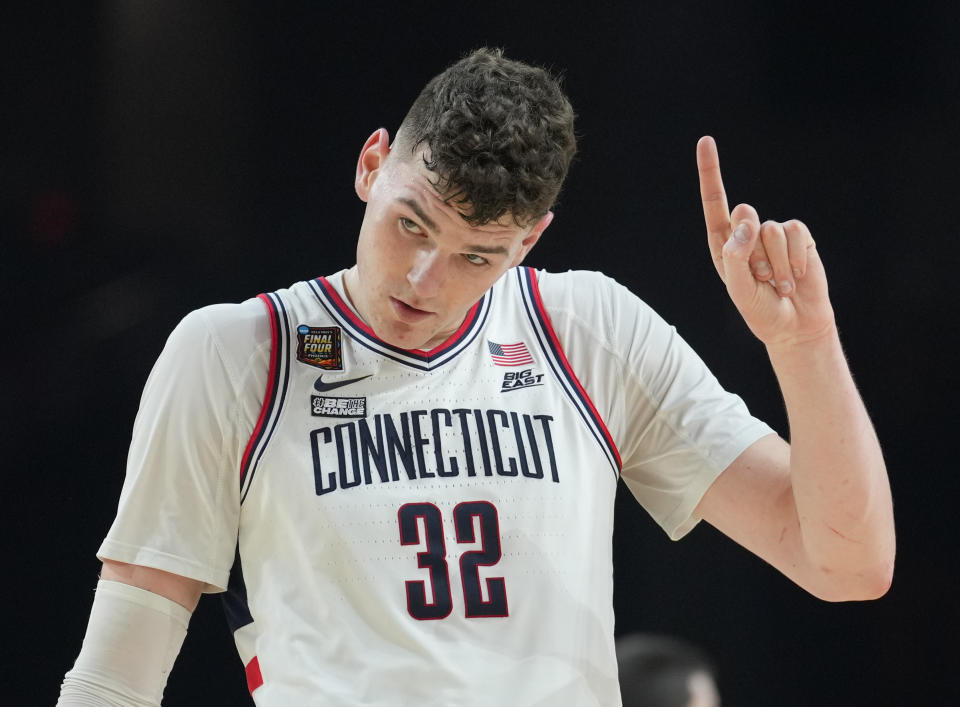 Apr 6, 2024; Glendale, AZ, USA; Connecticut Huskies center Donovan Clingan (32) reacts against the Alabama Crimson Tide in the semifinals of the men's Final Four of the 2024 NCAA Tournament at State Farm Stadium. Mandatory Credit: Robert Deutsch-USA TODAY Sports