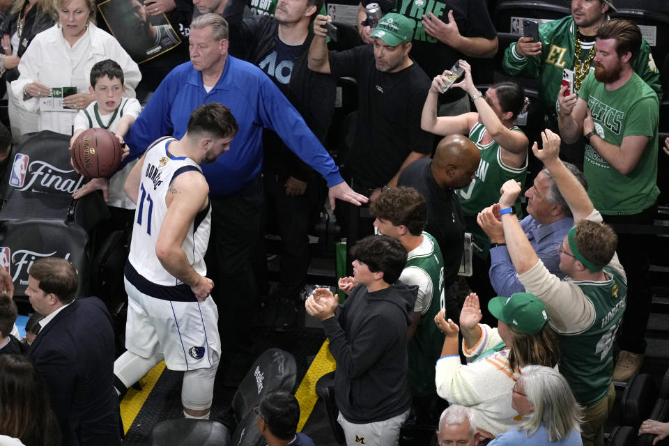 Dallas Mavericks guard Luka Doncic (77) heads to the locker room after a 105-98 loss to the Boston Celtics following Game 2 of the NBA Finals basketball series, Sunday, June 9, 2024, in Boston. (AP Photo/Michael Dwyer)