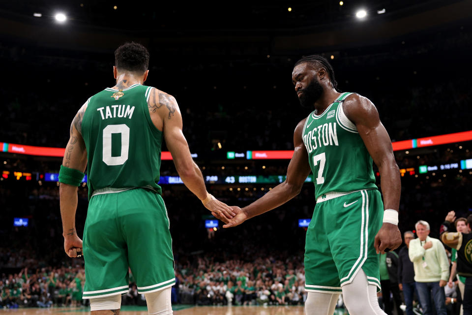 BOSTON, MASSACHUSETTS - JUNE 17: Jayson Tatum #0 high fives Jaylen Brown #7 of the Boston Celtics after a play against the Dallas Mavericks during the second quarter of Game Five of the 2024 NBA Finals at TD Garden on June 17, 2024 in Boston, Massachusetts. NOTE TO USER: User expressly acknowledges and agrees that, by downloading and or using this photograph, User is consenting to the terms and conditions of the Getty Images License Agreement. (Photo by Elsa/Getty Images)