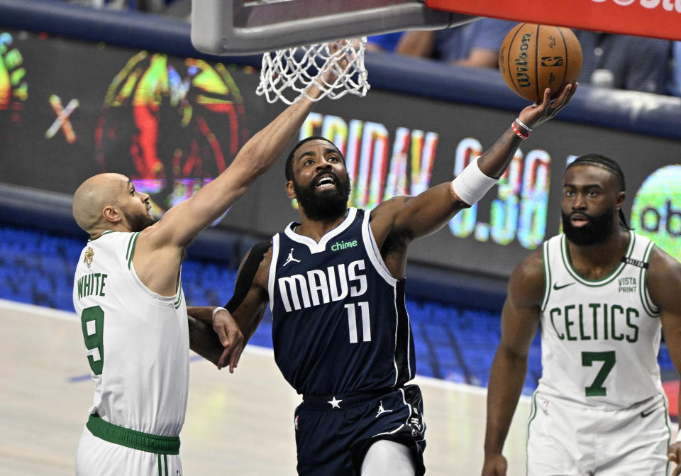 Jun 12, 2024; Dallas, Texas, USA; Dallas Mavericks guard Kyrie Irving (11) shoots against Boston Celtics guard Derrick White (9) during the third quarter in game three of the 2024 NBA Finals at American Airlines Center. Mandatory Credit: Jerome Miron-USA TODAY Sports