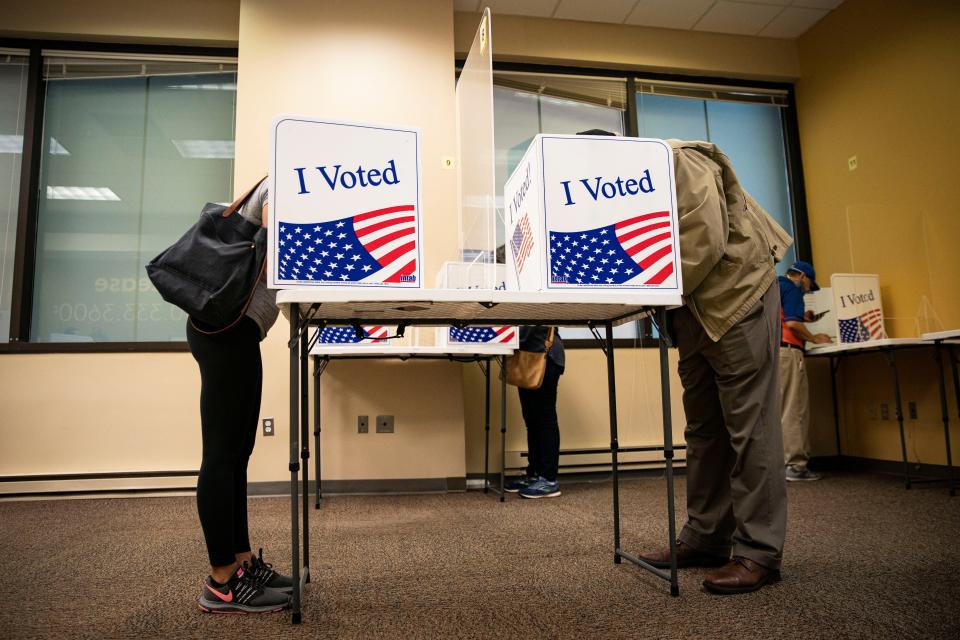 People fill out their ballots at an early voting site in Arlington, Virginia on September 18, 2020.