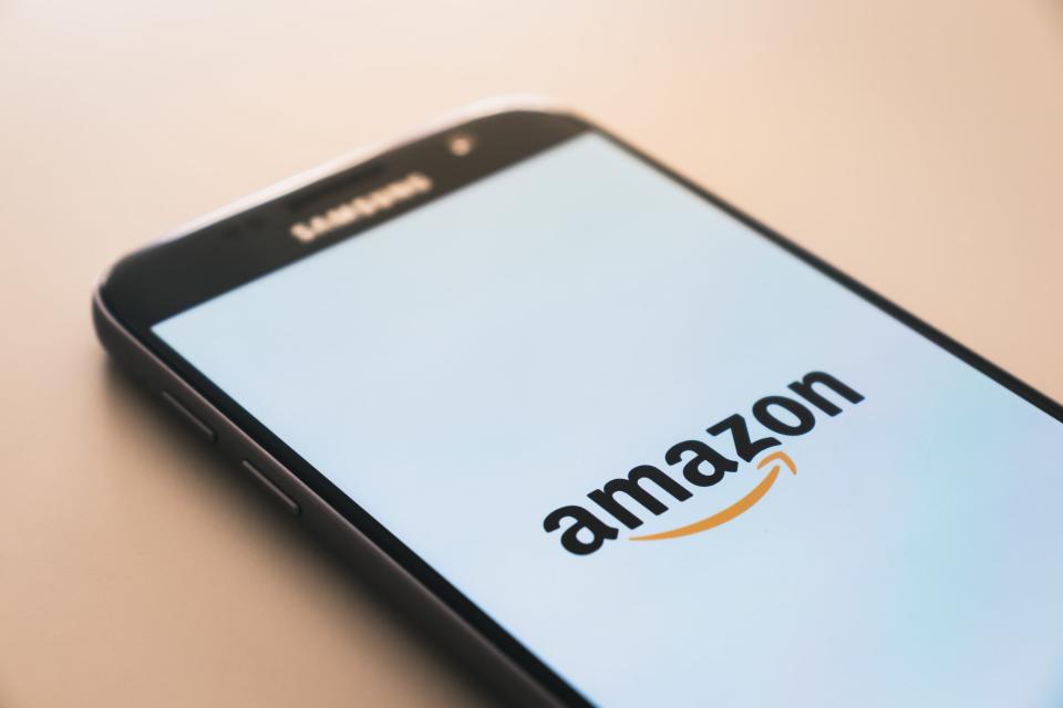 Smartphone displaying Amazon logo. Photo by Christian Wiediger via Unsplash.