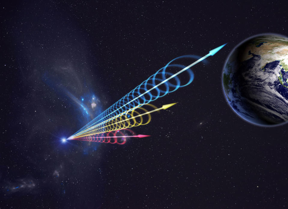 earth on the top right corner with red, yellow and blue wavelengths reaching it from a fast radio burst.