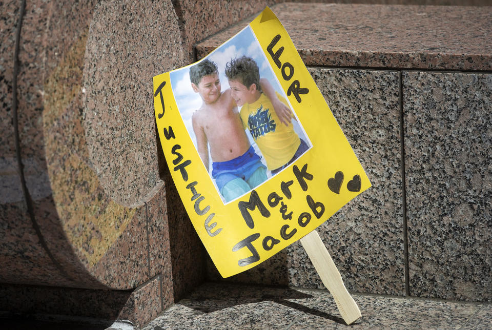A sign shows an image of  Mark Iskander, 11, left, and his brother Jacob Iskander, 8, (Mel Melcon / Los Angeles Times via Getty Images file)