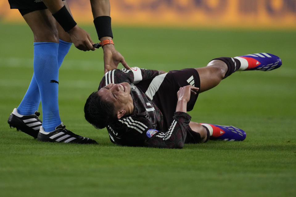 Mexico's Edson Alvarez grimaces in pain during a Copa America Group B soccer match against Jamaica in Houston, Texas, Saturday, June 22, 2024. (AP Photo/David J. Phillip)