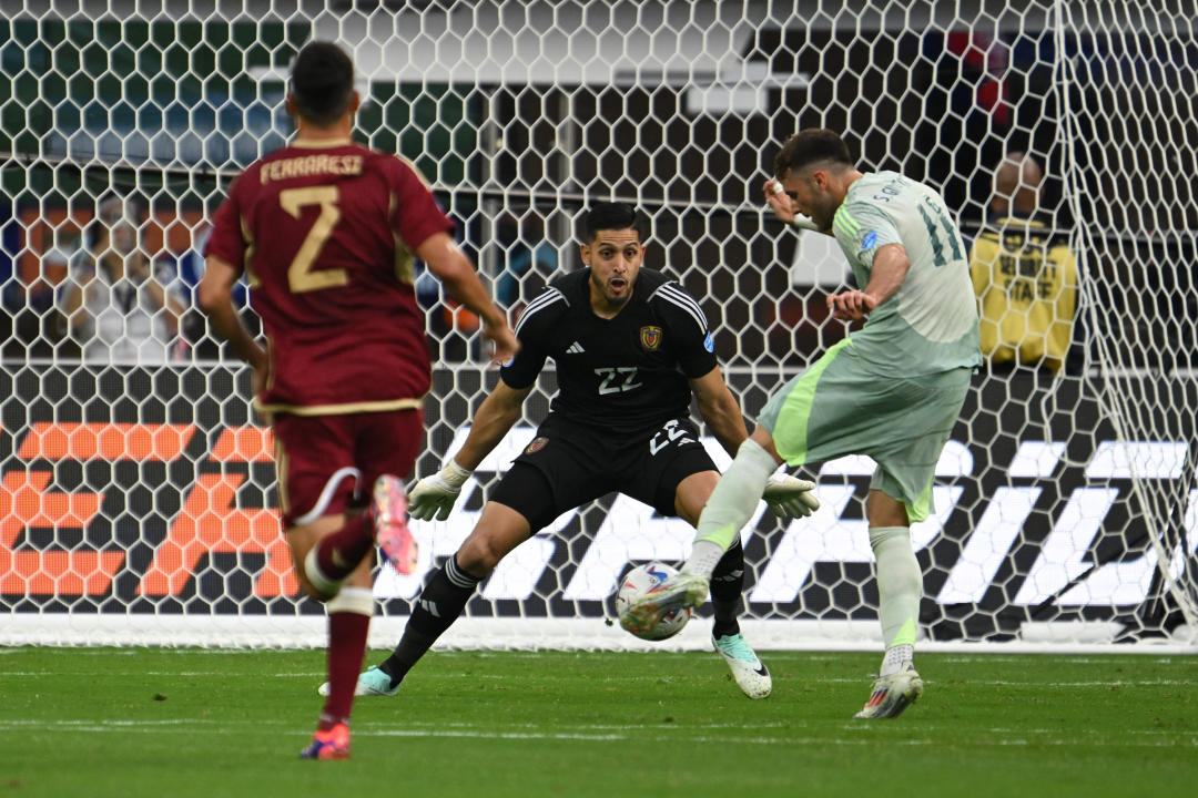 Venezuela's goalkeeper #22 Rafael Romo watches as Mexico's forward #11 Santiago Gimenez takes a shot on goal during the Conmebol 2024 Copa America tournament group B football match between Venezuela and Mexico at SoFi Stadium in Inglewood, California on June 26, 2024. (Photo by Patrick T. Fallon / AFP) (Photo by PATRICK T. FALLON/AFP via Getty Images)