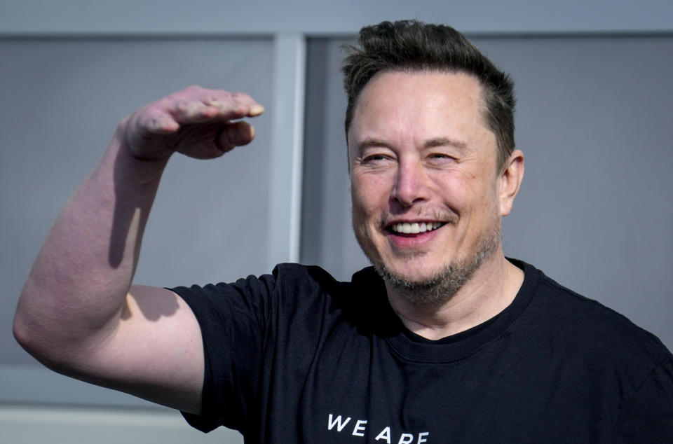 FILE - Tesla CEO Elon Musk waves as he leaves the Tesla Gigafactory for electric cars in Gruenheide near Berlin, Germany on March 13, 2024. Tesla shareholders are charting the future of the electric vehicle company Thursday, June 13, 2024, as they wrap up voting whether or not to restore Musk's massive pay package that was thrown out by a Delaware judge. (AP Photo/Ebrahim Noroozi, File)