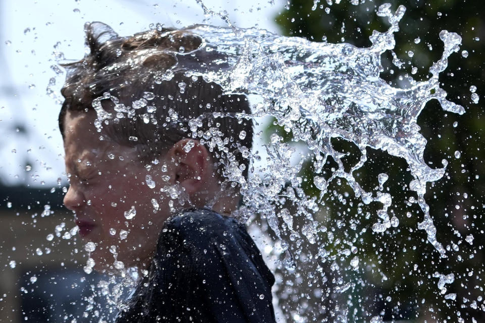 A boy cools off at a fountain during in Chicago. (Nam Y. Huh / AP)