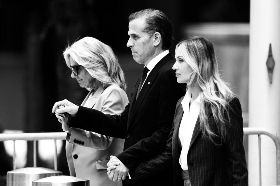 Hunter Biden holds his wife and mother's hands as they walk out of the courthouse (Matt Rourke / AP)