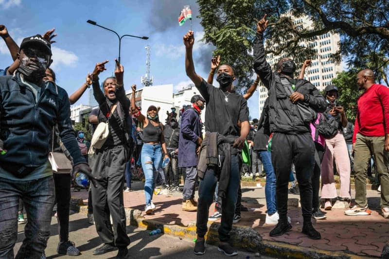 Protesters chant slogans during the demonstration. Kenyan law enforcement fired teargas and live ammunition into the largely peaceful crowd, with unconfirmed reports of several dead on social media. Protesters called for members of Kenya's Parliament to reject the proposed legislation, which would increase taxes across the country's economy. Katie G. Nelson/SOPA Images via ZUMA Press Wire/dpa