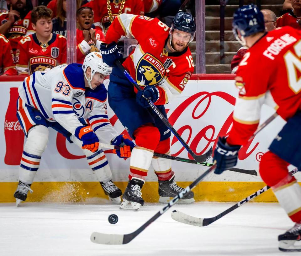Sunrise, Florida, June 8, 2024 - Florida Panthers center Aleksander Barkov (16) passes the puck to Florida Panthers defenseman Gustav Forsling (42) as Edmonton Oilers center Ryan Nugent-Hopkins (93) defends on the play in second period action during game 1 of the Stanley Cup Final at Amerant Arena in Sunrise, Florida.