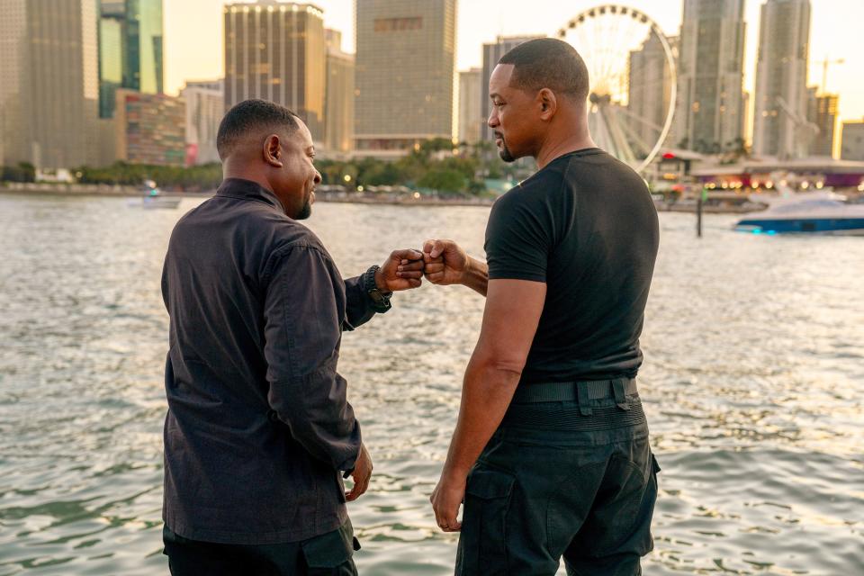 Will Smith and Martin Lawrence bump fists by a river.