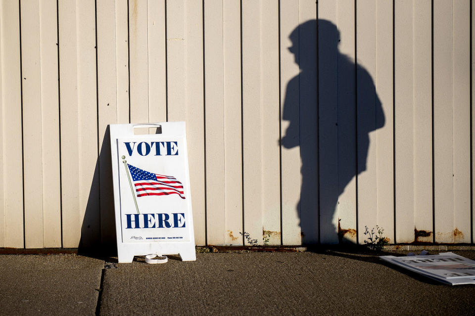 Image: A voter walks toward the entrance of the Boys and Girls Clubs of the Great Lakes Bay Region to cast their ballot in Bay City, Mich., during Election Day on Nov. 3, 2020. (Kaytie Boomer / The Bay City Times via AP file)