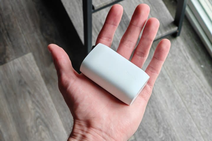 Someone holding a white Belkin charger.