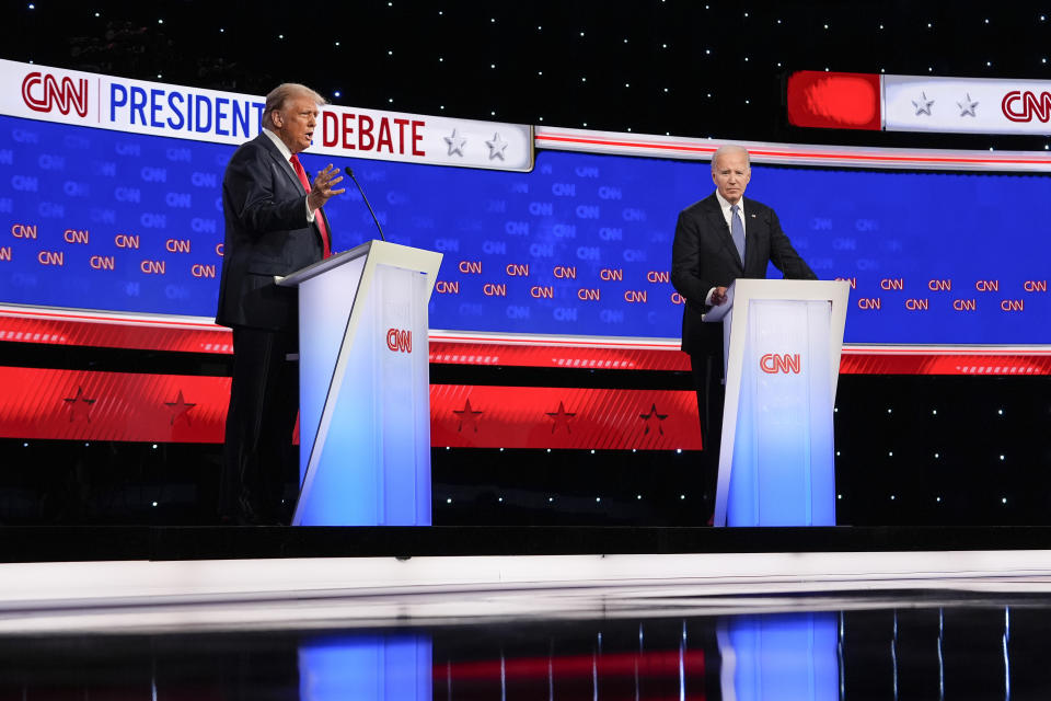 President Joe Biden, right, listens as Republican presidential candidate former President Donald Trump speaks during a presidential debate hosted by CNN, Thursday, June 27, 2024, in Atlanta. (AP Photo/Gerald Herbert)