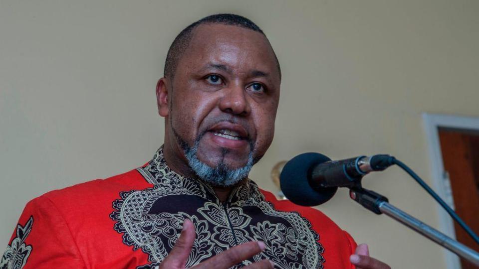 Malawi's former Vice-President Saulos Chilima wearing a red and black African print shirt