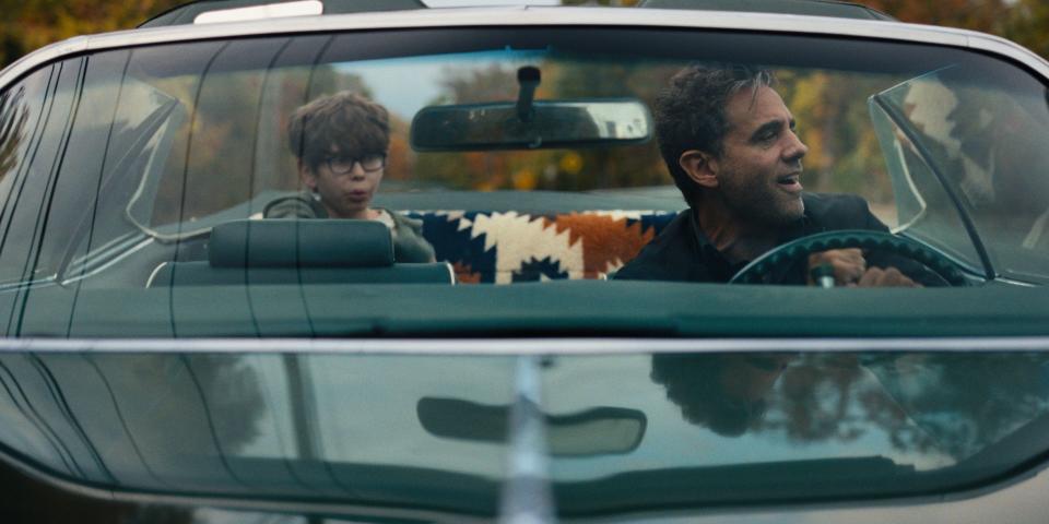 Cannavale drives as Fitzgerald sits in the back seat in the movie Ezra.
