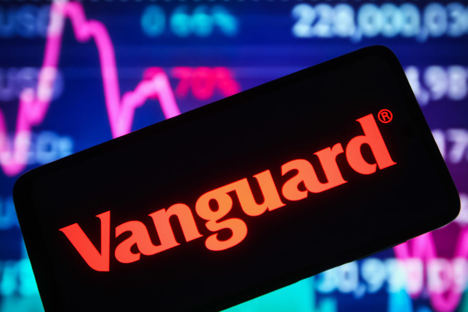 UKRAINE - 2021/12/30: In this photo illustration, the Vanguard Group Inc. logo is seen displayed on a smartphone screen and a stock market line graph is seen in the background. (Photo Illustration by Pavlo Gonchar/SOPA Images/LightRocket via Getty Images)