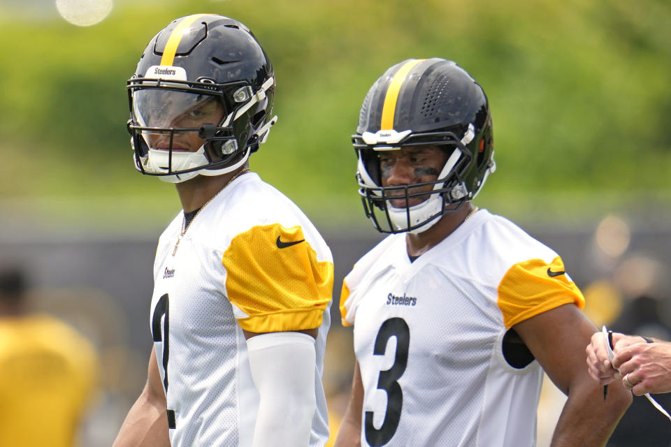 Pittsburgh Steelers quarterbacks Justin Fields, left, and Russell Wilson (3) participate in the team's NFL OTA's football practice in Pittsburgh, Tuesday, May 21, 2024. (AP Photo/Gene J. Puskar)