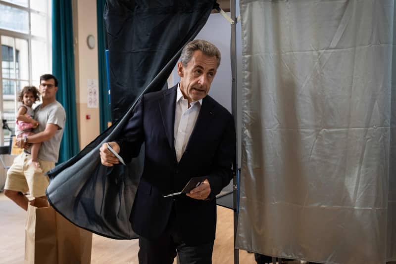 Former French President Nicolas Sarkozy leaves the polling booth before casting his vote in the first round of the parliamentary elections. Arnaud Finistre/AFP/dpa