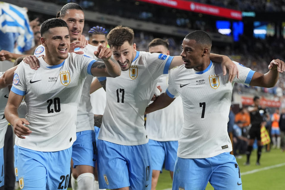 Uruguay's Maximiliano Araujo, left, celebrates with teammates after scoring his side's third goal against Bolivia during a Copa America Group C soccer match in East Rutherford, N.J., Thursday, June 27, 2024. (AP Photo/Julia Nikhinson)