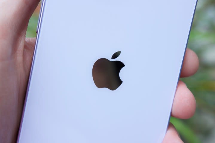 The Apple logo on the back of an iPhone 14.