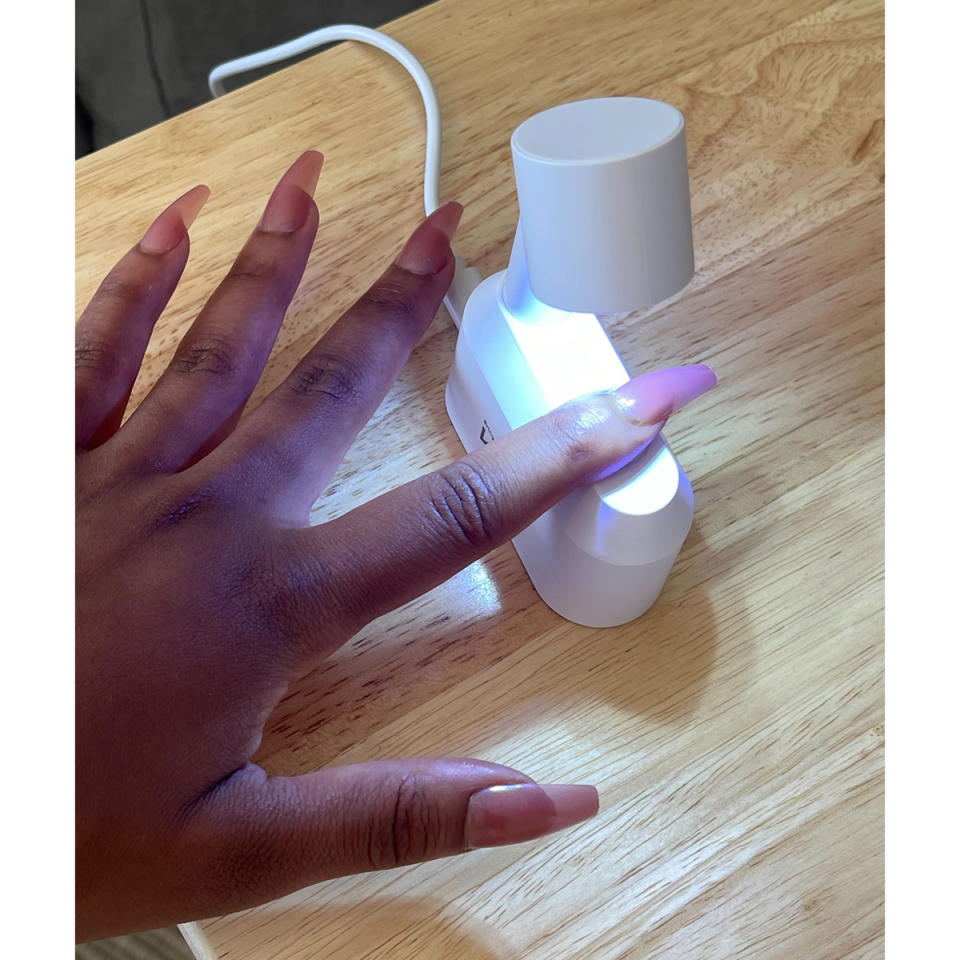 Setting each finger under the mini LED lamp.