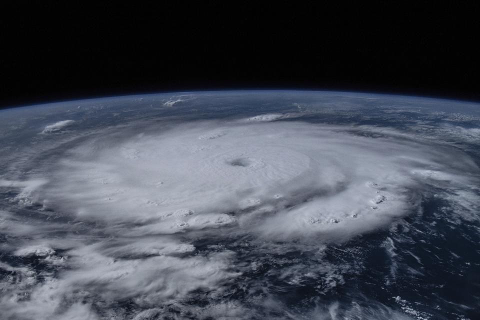 Image from space of Earth with massive spiraling cloud structure.