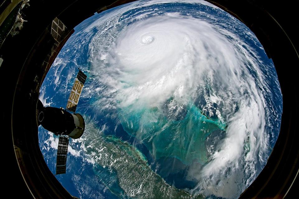 View of Earth and a large hurricane from a portal on the space station.