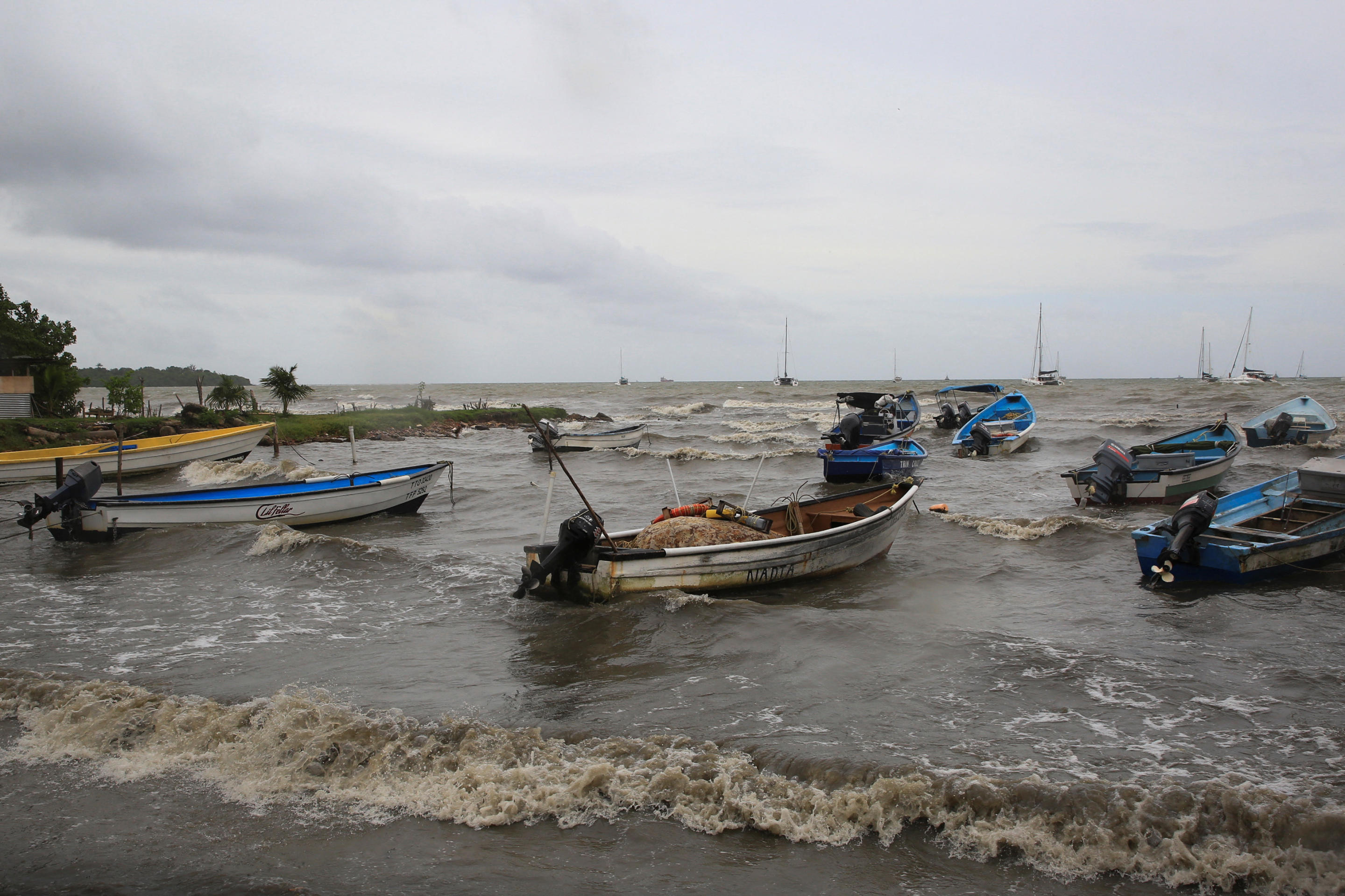 About a dozen small boats in the water near shore after Hurricane Beryl made landfall in Port of Spain, the capital of Trinidad and Tobago. 